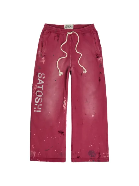SATOSHI NAKAMOTO distressed paint-splatter track pants Red SS26PNT010BUR