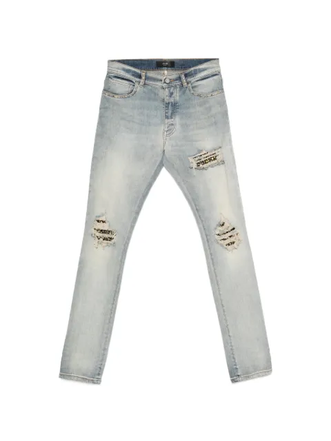 AMIRI stud-embellished distressed jeans Blue AMBMJE1123