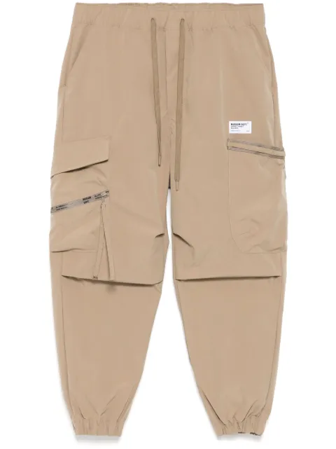 Musium Div. logo-patch trousers Neutrals MMUPTM00729X