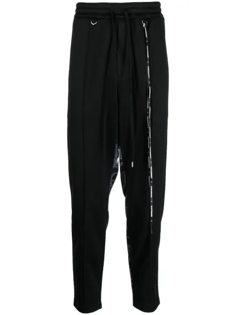 Mastermind World camouflage-print track pants Black ILLPT22A029